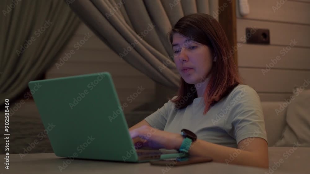 Woman typing on laptop computer working in internet, doing online job at home. Woman typing on laptop computer working in internet, doing online job at home.