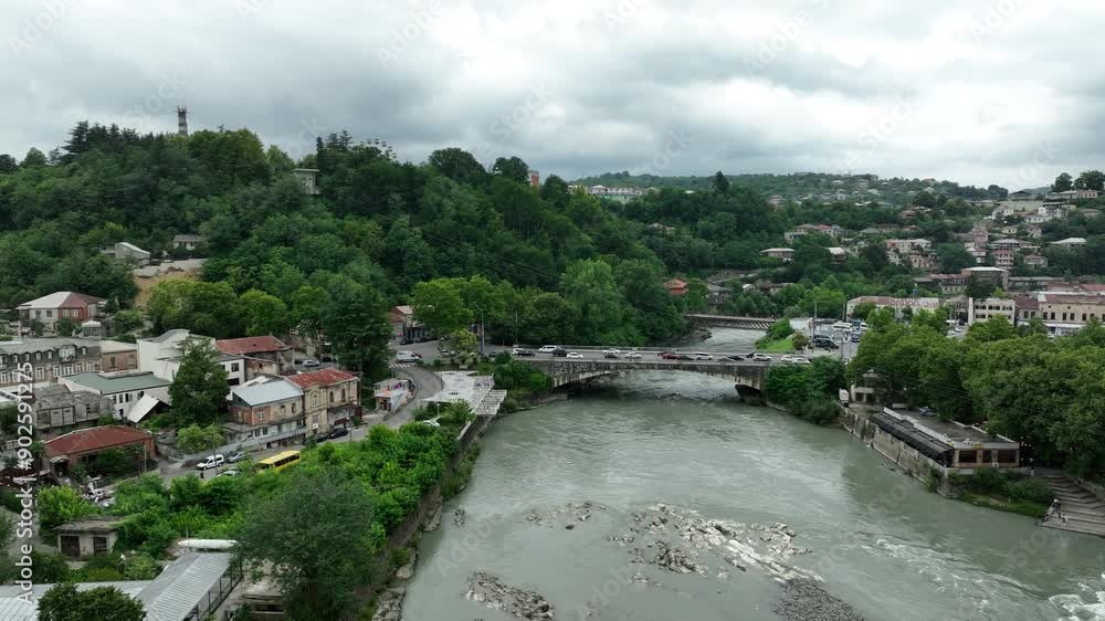 Aerial view of Kutaisi cityscape at sunset in Georgia. Drone footage of the Kutaisi city center, white bridge over the Rioni river Aerial view of Kutaisi cityscape at sunset in Georgia. Drone footage of the Kutaisi city center, white bridge over the Rioni river