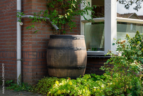 Tableau sur toile Rain barrel on exterior of modern house, saving rainwater to reuse it in the gar