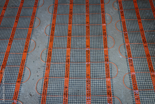 Underfloor heating installation. Electric cabling and conductive meshwork is seen.