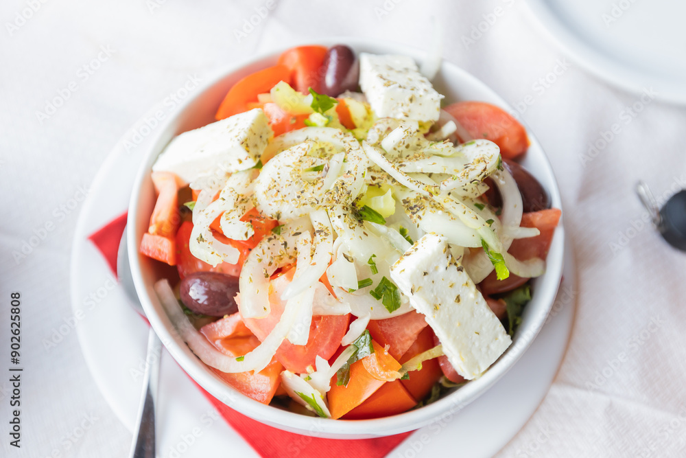 Fresh Greek Salad With Tomatoes, Cucumbers, Olives, Onions, And Feta Cheese, Beautifully Presented On A Rustic Restaurant Table. Perfect For Food And Culinary Themes Fresh Greek Salad With Tomatoes, Cucumbers, Olives, Onions, And Feta Cheese, Beautifully Presented On A Rustic Restaurant Table. Perfect For Food And Culinary Themes