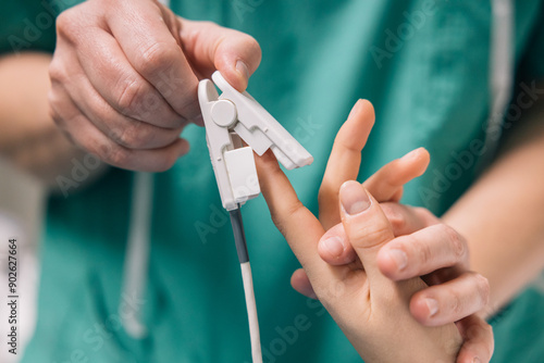 Healthcare worker setting up cardiac monitoring equipment on a patient in a medical facility