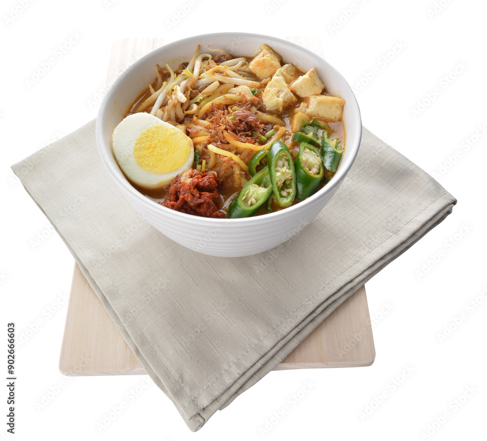 Malay mee rebus noodle with boiled egg, tofu, green chilli, sambal, vegetable, chilli sauce and hot thick spicy gravy soup in bowl on white background asian halal food cuisine menu for cafe design