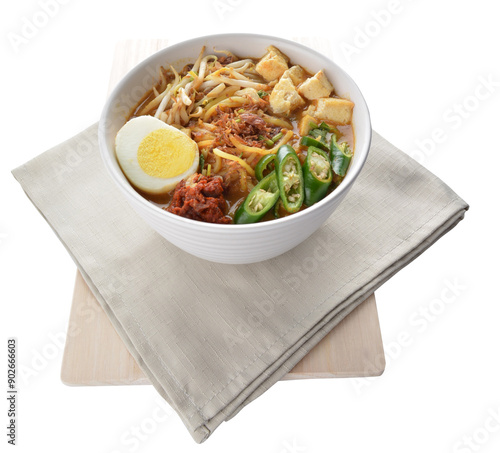 Obraz na płótnie Malay mee rebus noodle with boiled egg, tofu, green chilli, sambal, vegetable, chilli sauce and hot thick spicy gravy soup in bowl on white background asian halal food cuisine menu for cafe design w salonie
