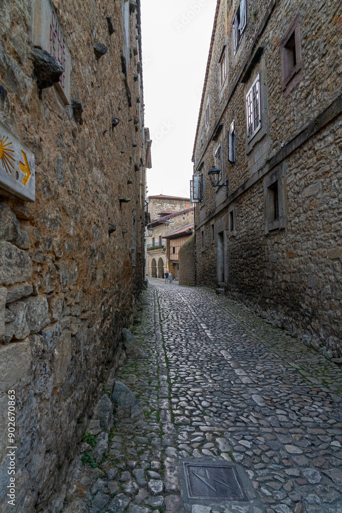 Quaint narrow alley with stone-paved path and historic buildings in Santillana del Mar, Spain. Perfect for travel, architecture, and cultural themes Quaint narrow alley with stone-paved path and historic buildings in Santillana del Mar, Spain. Perfect for travel, architecture, and cultural themes