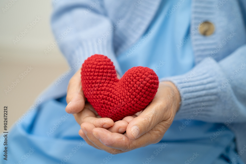 Asian doctor give red heart to elderly woman in her hand, heart Attack. Asian doctor give red heart to elderly woman in her hand, heart Attack.
