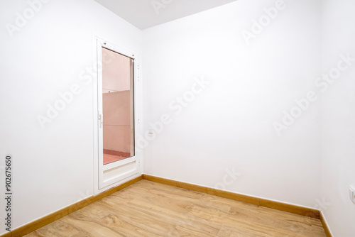 Wallpaper Mural An empty room with a single door leading outside, showcasing beautiful wooden flooring and white walls, ideal for design and home improvement ideas. Torontodigital.ca