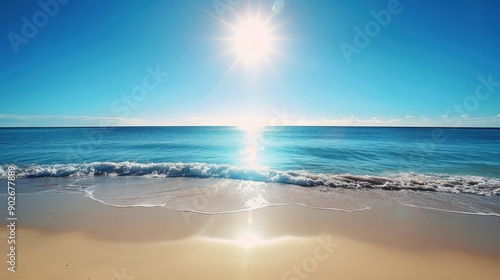 Beautiful sunny beach with calm waves and clear blue sky. Perfect summer vacation destination with bright sunshine reflecting on the water.