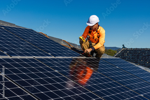 Solar panel technician with power meter and solar panels