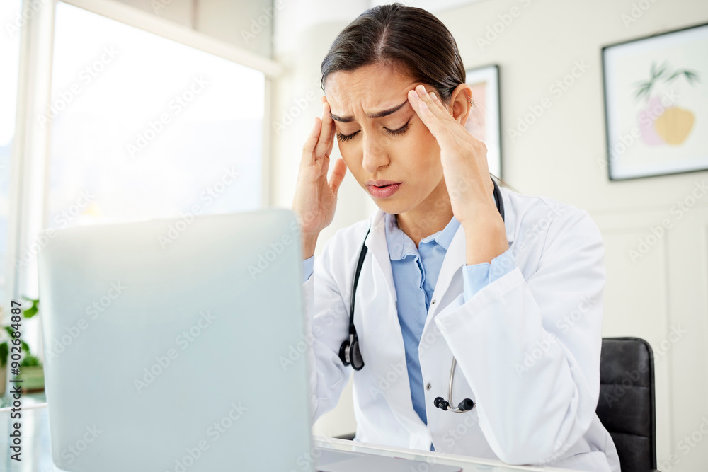 Doctor, woman and laptop with headache from stress in office with burnout, overworked or mental health at desk. Medical, professional or frustrated with migraine, anxiety or ache from clinic overtime Doctor, woman and laptop with headache from stress in office with burnout, overworked or mental health at desk. Medical, professional or frustrated with migraine, anxiety or ache from clinic overtime