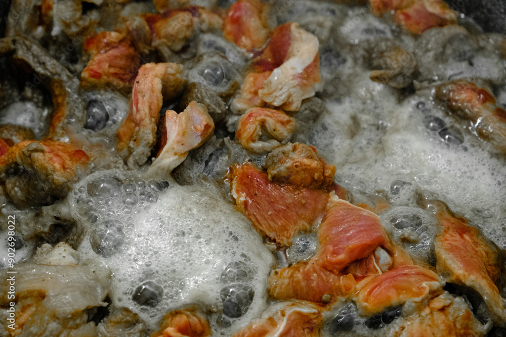 A closeup view of a pot filled with food that is foaming out of it A closeup view of a pot filled with food that is foaming out of it