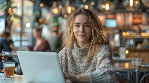 Young Woman Working on Laptop in Cozy Café During Afternoon