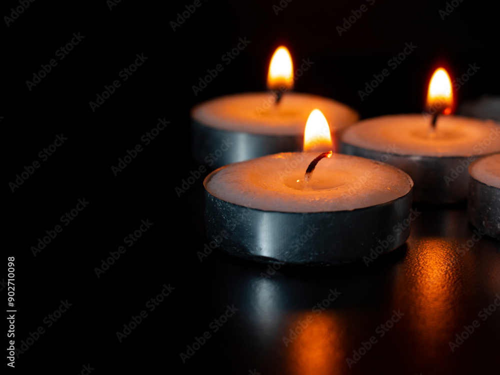 Candles shining on dark background with customizable space for text of message. Copy space concept Candles shining on dark background with customizable space for text of message. Copy space concept