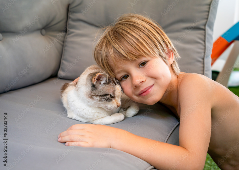 Portrait of a cheerful child boy hugging small cat outdoor. Portrait of a cheerful child boy hugging small cat outdoor.