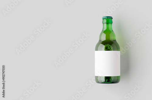 Green steinie beer bottle mockup with a blank label and copyspace. photo