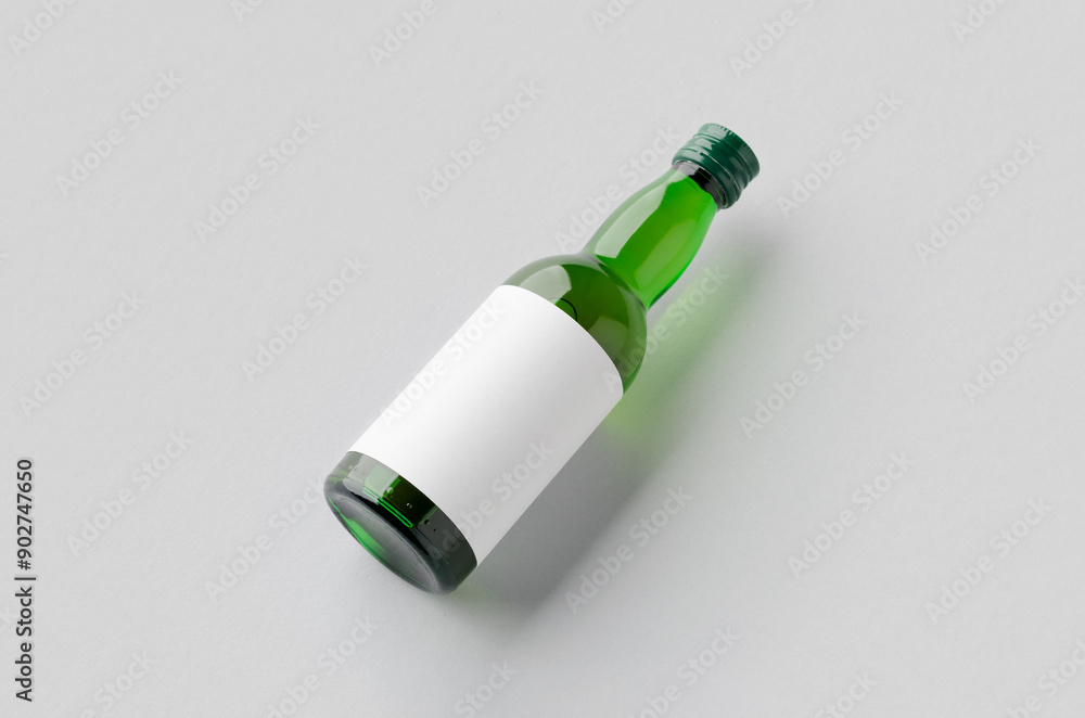 Miniature spirits, liquor bottle mockup. Green glass with a blank label. Miniature spirits, liquor bottle mockup. Green glass with a blank label.