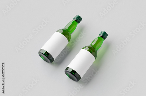 Miniature spirits, liquor bottle mockup. Green glass with a blank label. photo