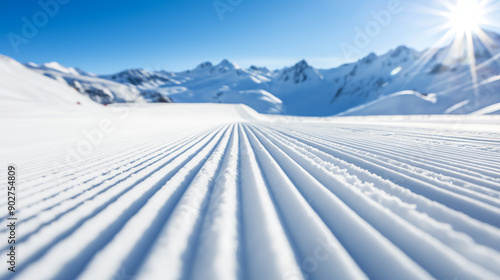 New groomed ski paste or slope. Lines in snow with sunny mountains background. Winter skis concept  photo