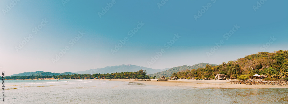 Canacona, Goa, India. Sunny Sky Over Calm Water Of Arabian Sea. Natural Landscape With Sandy Palolem Beach At Sunny Summer Day With Blue Sky Canacona, Goa, India. Sunny Sky Over Calm Water Of Arabian Sea. Natural Landscape With Sandy Palolem Beach At Sunny Summer Day With Blue Sky