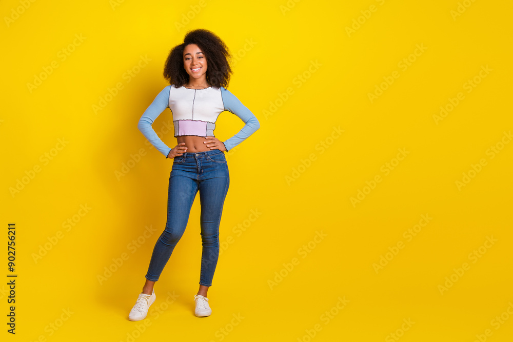 Full size photo of pretty young girl posing cute model wear trendy blue outfit isolated on yellow color background Full size photo of pretty young girl posing cute model wear trendy blue outfit isolated on yellow color background