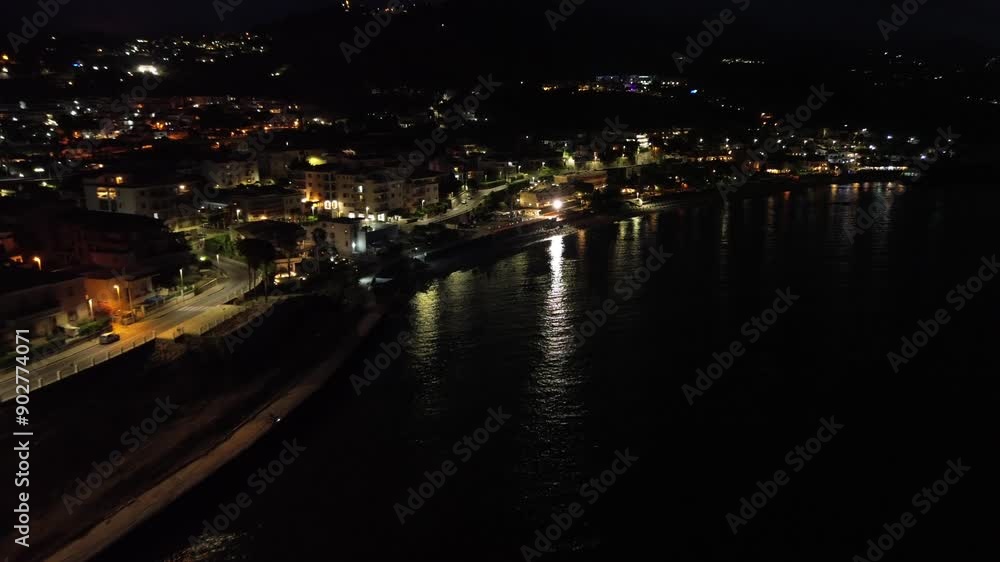 Breathtaking night aerial view over the seaside town of Diamante near Scalea in Calabria with the main street illuminated 3
