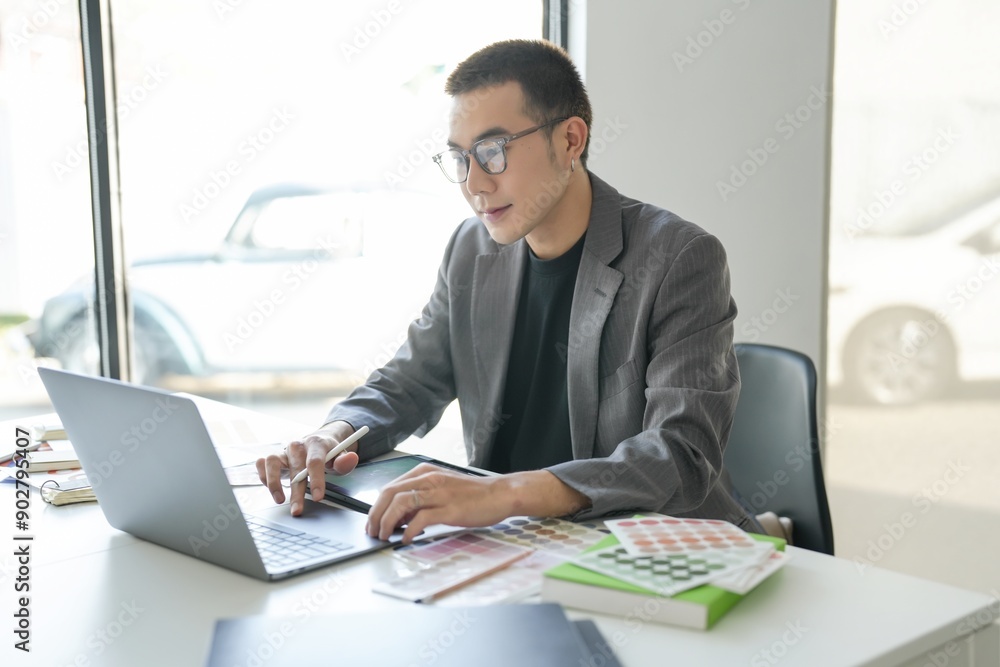 Business asian Man Artist Creative Designer sketch graphic drawing on graphic laptop and Color swatch samples Concept of idea creativity Business asian Man Artist Creative Designer sketch graphic drawing on graphic laptop and Color swatch samples Concept of idea creativity