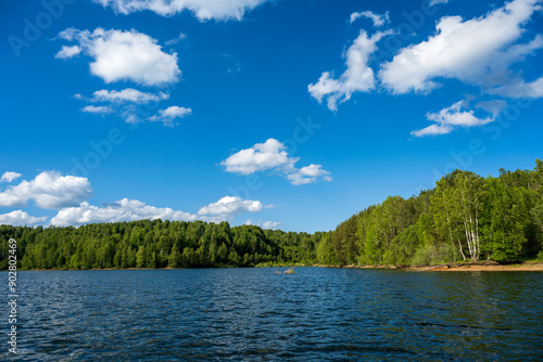 Vlasina lake scenery with beautiful clouds in the blue sky. Beautiful semi-artificial lake in Southeast Serbia. The beautiful blue color of the water.