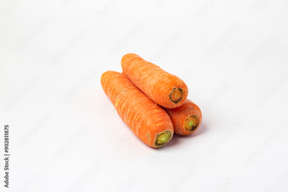 Front view and side view of fresh beautiful orange carrots with slices or pieces in a stack is isolated on white background with clipping path.