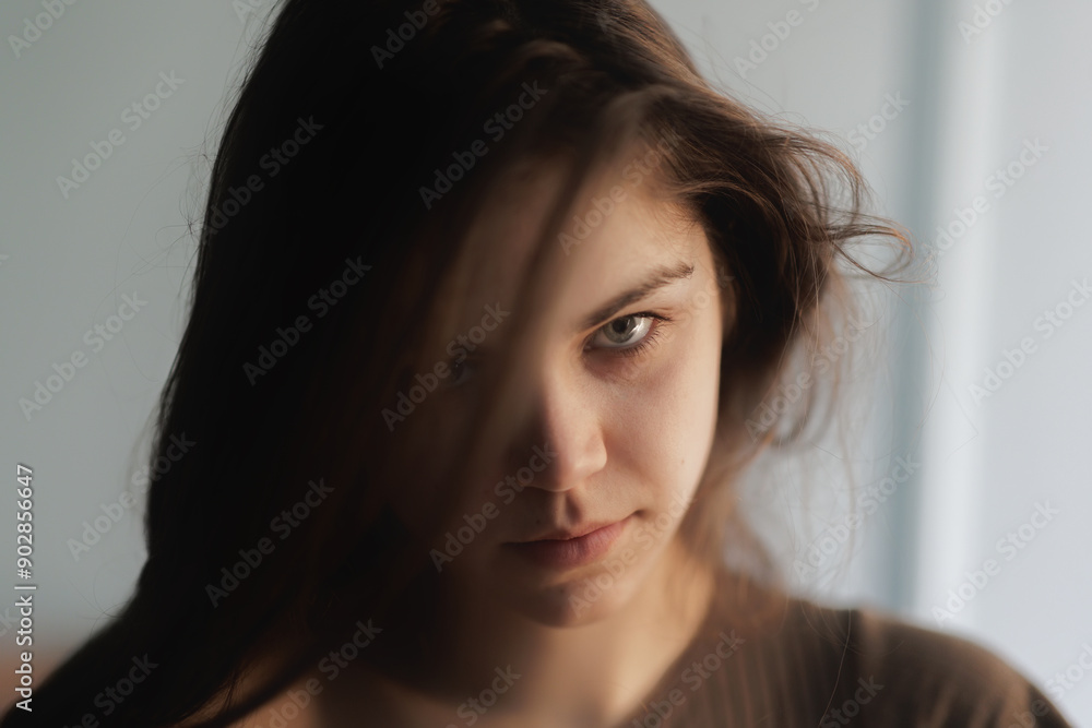 Thoughtful young woman with intense gaze Thoughtful young woman with intense gaze