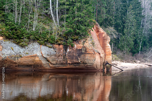 landscape with sandstone cliffs on the river bank, sandy river bank, old last year's grass, nature without greenery, Erglu cliffs, Cesu county, Latvia photo