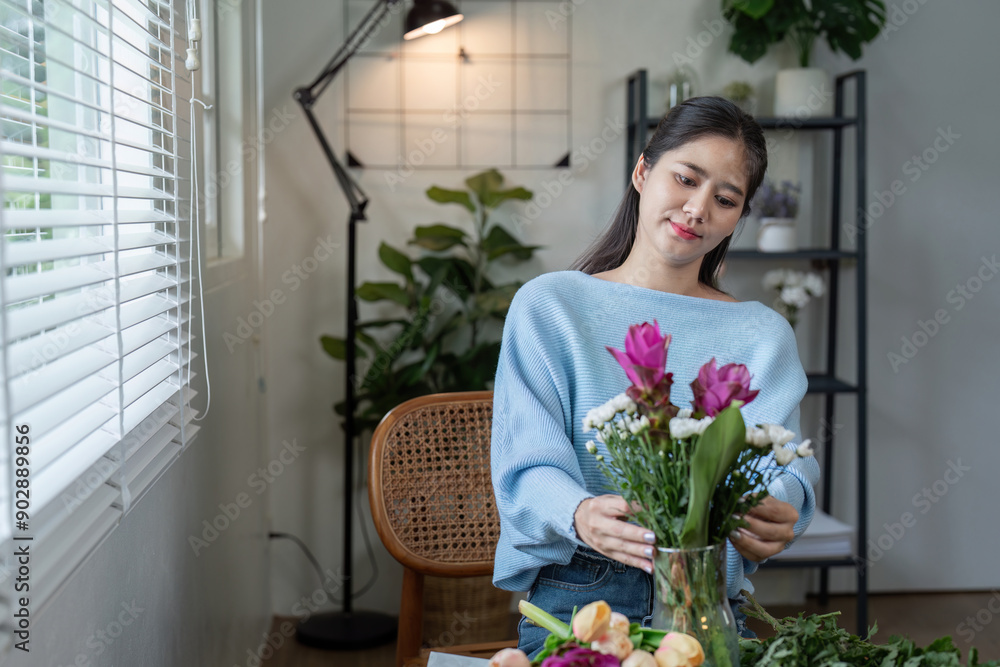 Young Woman Arranging Fresh Flowers in a Vase at Home with Modern Interior Design and Natural Light Young Woman Arranging Fresh Flowers in a Vase at Home with Modern Interior Design and Natural Light