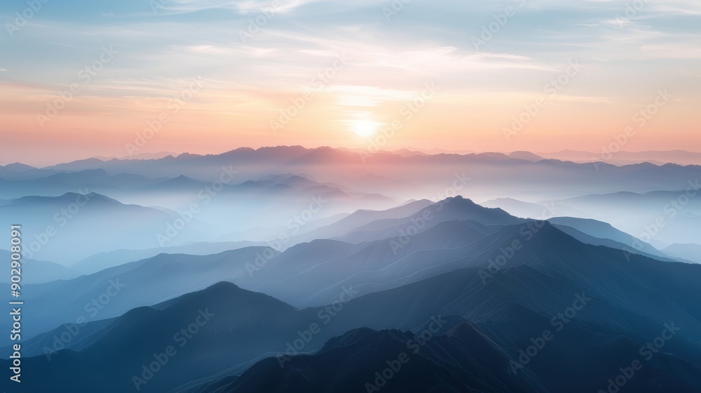 Obraz premium A stunning foggy mountain range at sunrise, with layers of hills creating a beautiful and serene landscape, highlighting the tranquility of the morning.