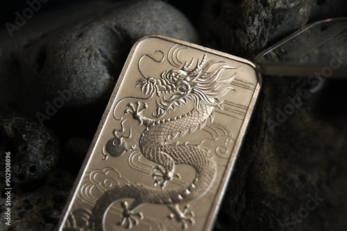 Pure silver bar with dragon close-up. Business and finance.