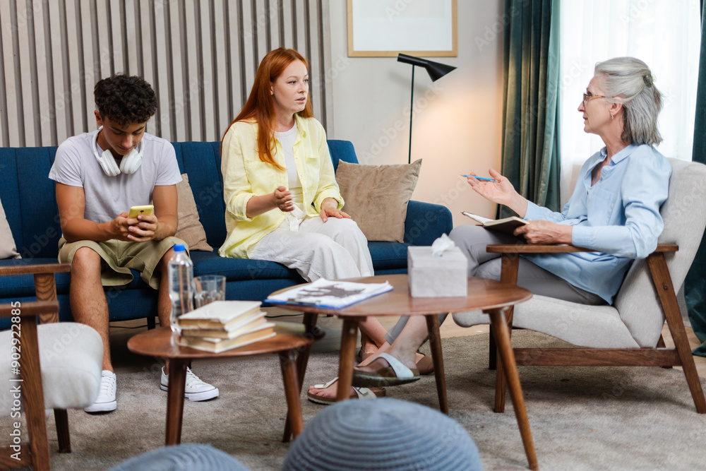Family, son and mother having conversation with therapist, psychologist taking notes Family, son and mother having conversation with therapist, psychologist taking notes