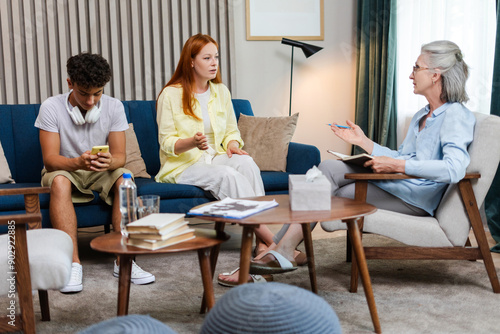 Family, son and mother having conversation with therapist, psychologist taking notes