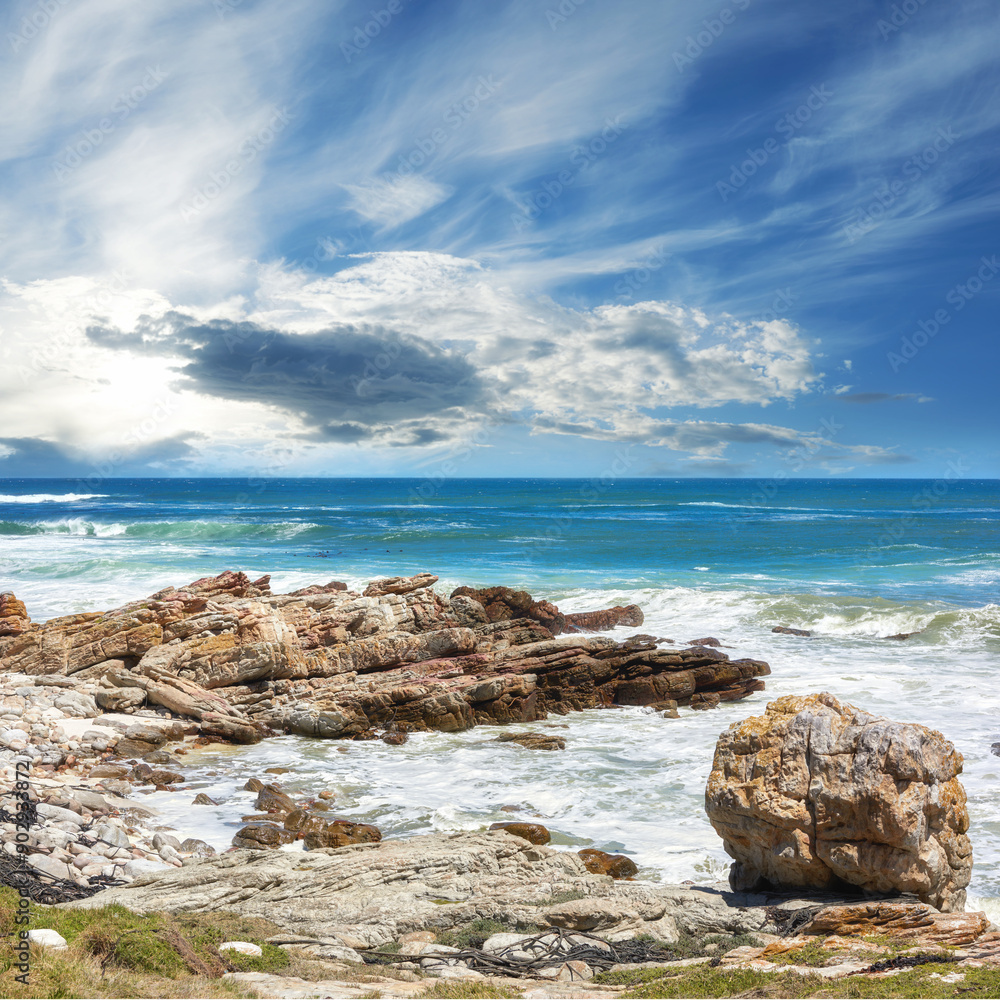 Ocean, water and rocks in nature outdoor for travel destination, coat environment and natural beauty. Blue sky, beach and scenery for seaside peace, tourism journey with adventure location of view Ocean, water and rocks in nature outdoor for travel destination, coat environment and natural beauty. Blue sky, beach and scenery for seaside peace, tourism journey with adventure location of view