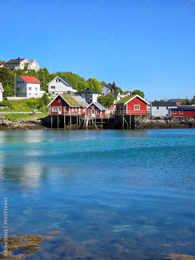 Naklejka premium Charming Red Cabins By The Tranquil Waters Of Norway's Coastal Village, Lofoten Norway