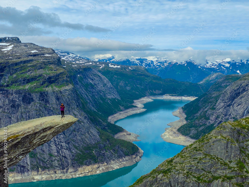 Fototapeta premium Breathtaking Hike at Trolltunga in Norway Surrounded by Majestic Fjords and Mountains