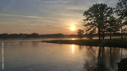 background, reflected in a still pond of water in the foreground.