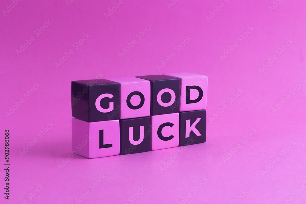 Good Luck text on a pink black Blocks with pink background Good Luck text on a pink black Blocks with pink background