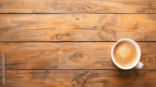 A wooden table with a white coffee cup on it. The wooden table has a rustic and natural feel to it