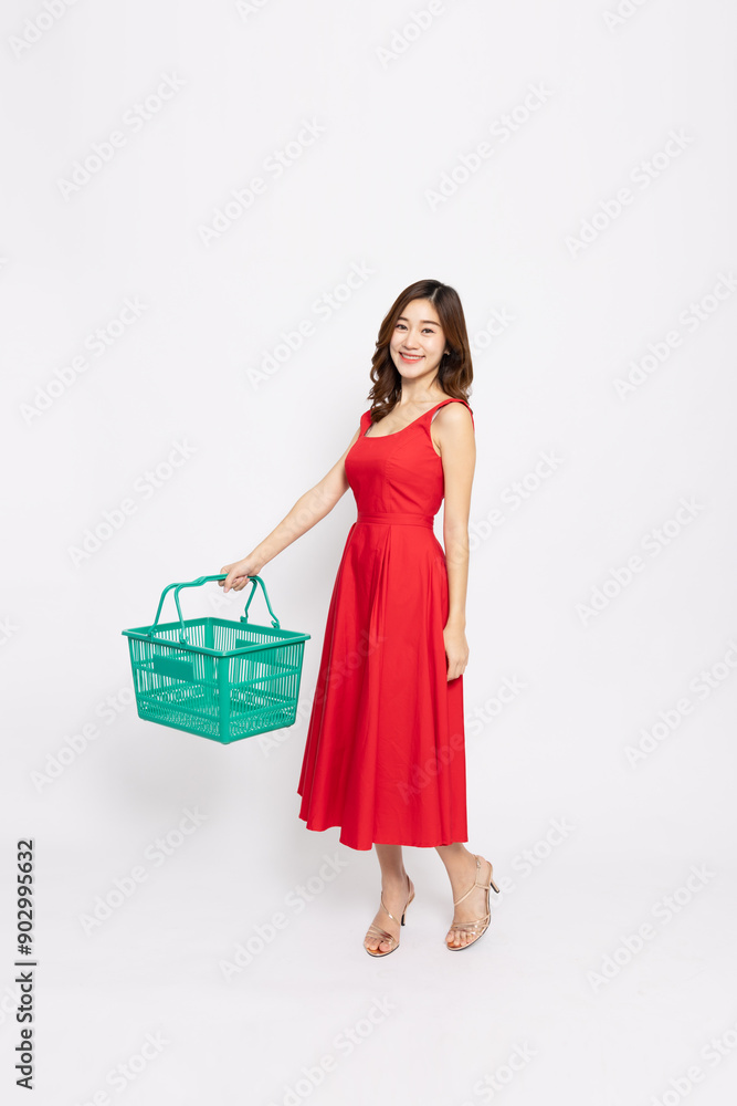 Young Asian woman in red dress and holding green grocery basket isolated on white background, Shopping and Supermarket concept, Full body composition