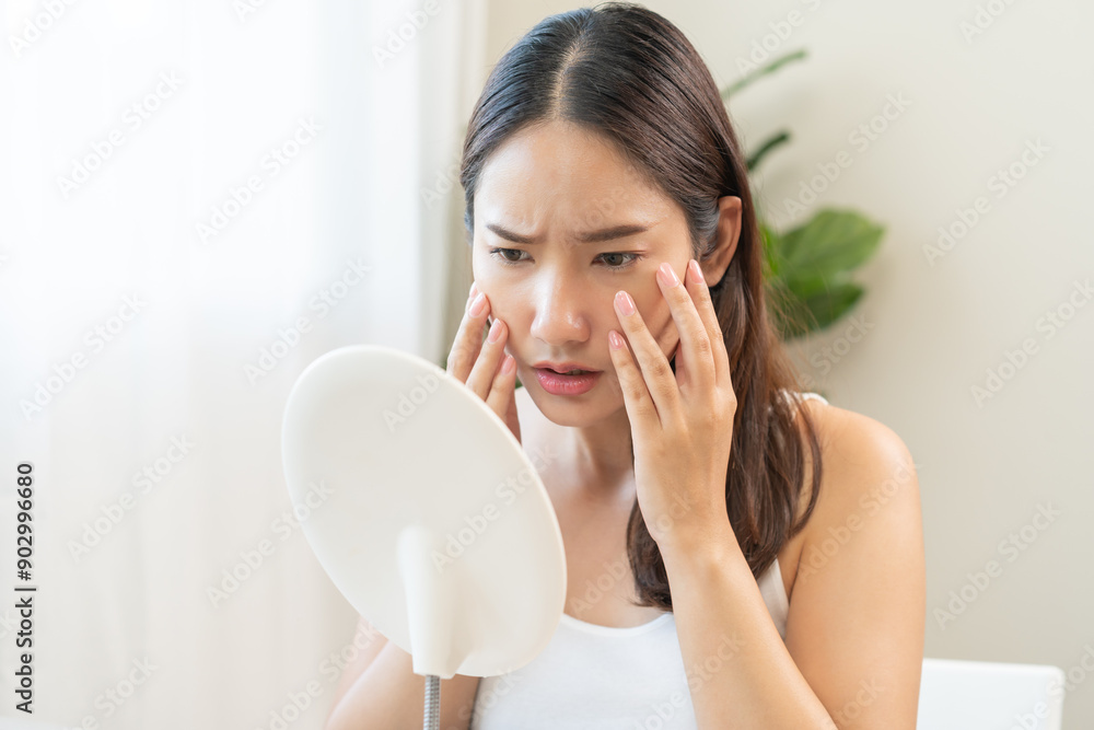 Anti wrinkle aging, worry puberty asian young woman, stressed looking in mirror, allergy presenting allergic reaction from cosmetic on face. Beauty, health care from acne problem, dry skin, treatment. Anti wrinkle aging, worry puberty asian young woman, stressed looking in mirror, allergy presenting allergic reaction from cosmetic on face. Beauty, health care from acne problem, dry skin, treatment.