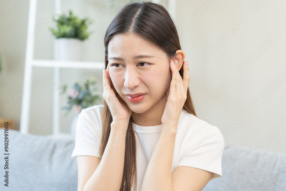 Tinnitus concept, sick asian young woman, girl have ear pain or earache, hand touch plug ear, suffering painful otitis from loud of noisy sound, inflammation. Health care nerve deaf eardrum disease. Tinnitus concept, sick asian young woman, girl have ear pain or earache, hand touch plug ear, suffering painful otitis from loud of noisy sound, inflammation. Health care nerve deaf eardrum disease.