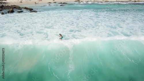 Aerial view of surfer catching a wave succesfullly in Cozumel Island, Riviera Maya, Mexico