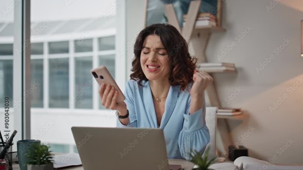 Satisfied businesswoman reading message on phone at office workspace closeup. Satisfied businesswoman reading message on phone at office workspace closeup.