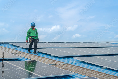 Worker Technicians are working to construct solar panels system on roof. Installing solar photovoltaic panel system. Men technicians walking on roof structure to check photovoltaic solar modules.