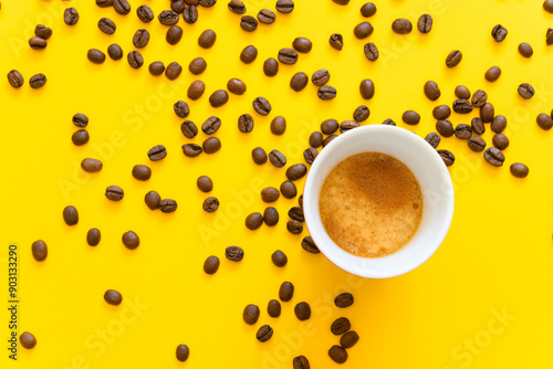 Fotografía Cup of espresso and whole coffee beans on a yellow background