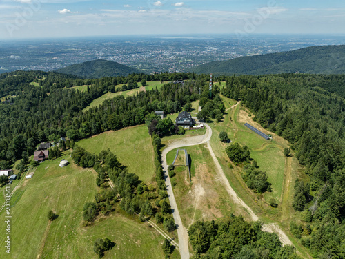 Stunning aerial drone view of summer green forests in the Beskids, Bielsko Biała, Magurka Wilkowicka. Shelter on Magurka Wilkowicka. Beskid summer mountains panorama. photo