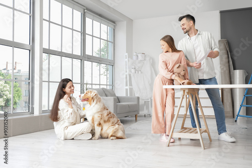 Happy family with dog durin...